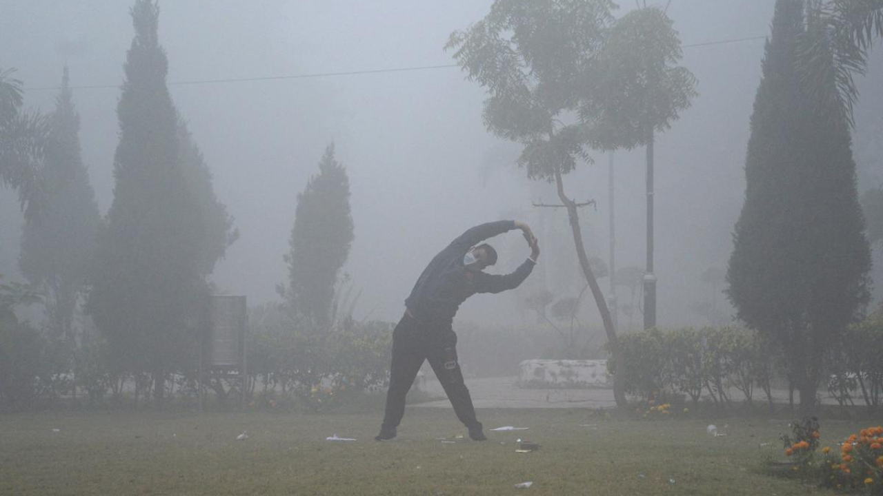 A man does exercises at a park amid dense fog, in Jalandhar. Credit: PTI