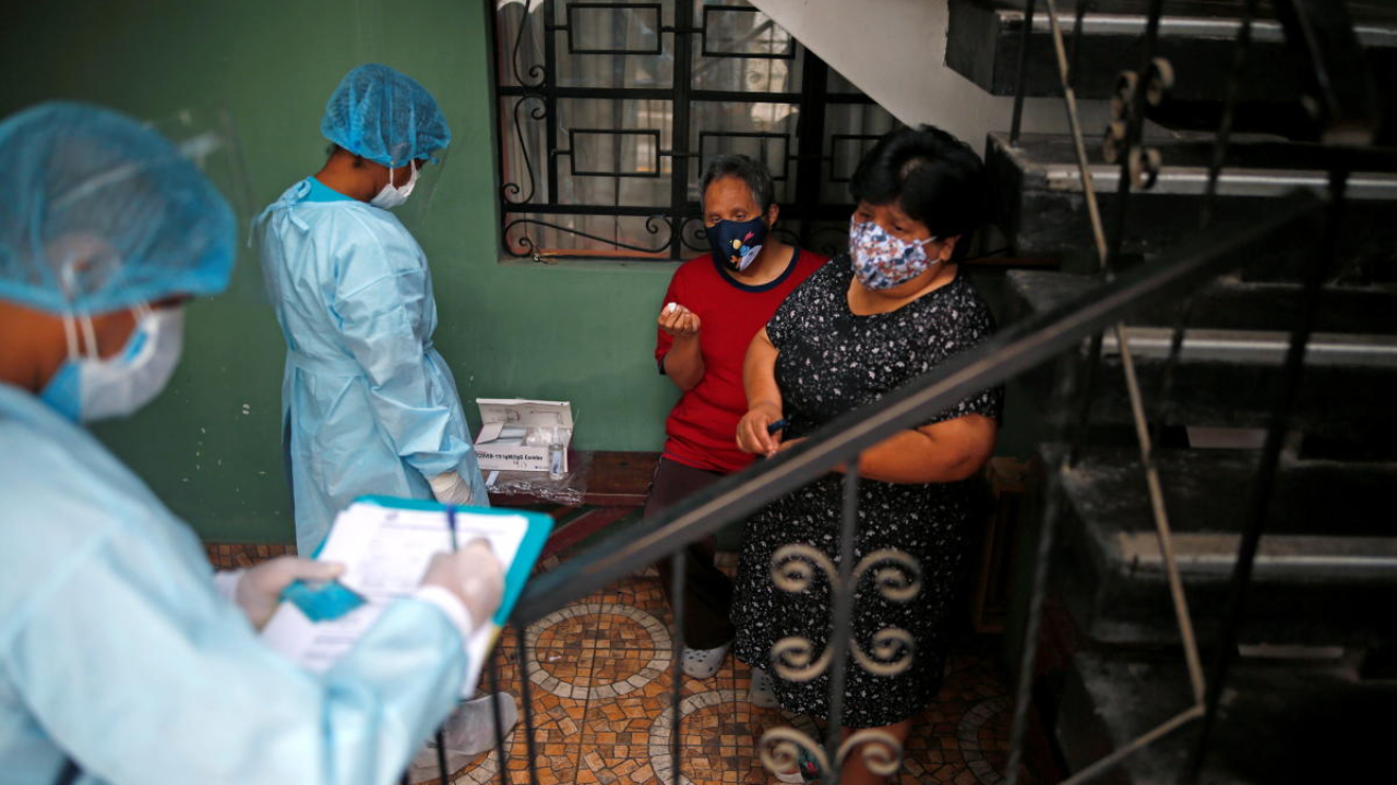 Medical workers take samples during mass testing for Covid-19 in Lima, Peru. Credit: Reuters Photo