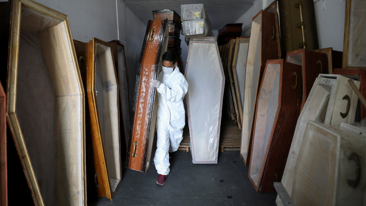Municipal workers get ready for their shift at SOS Funeral, in Manaus, state of Amazonas, Brazil. Credit: AFP Photo