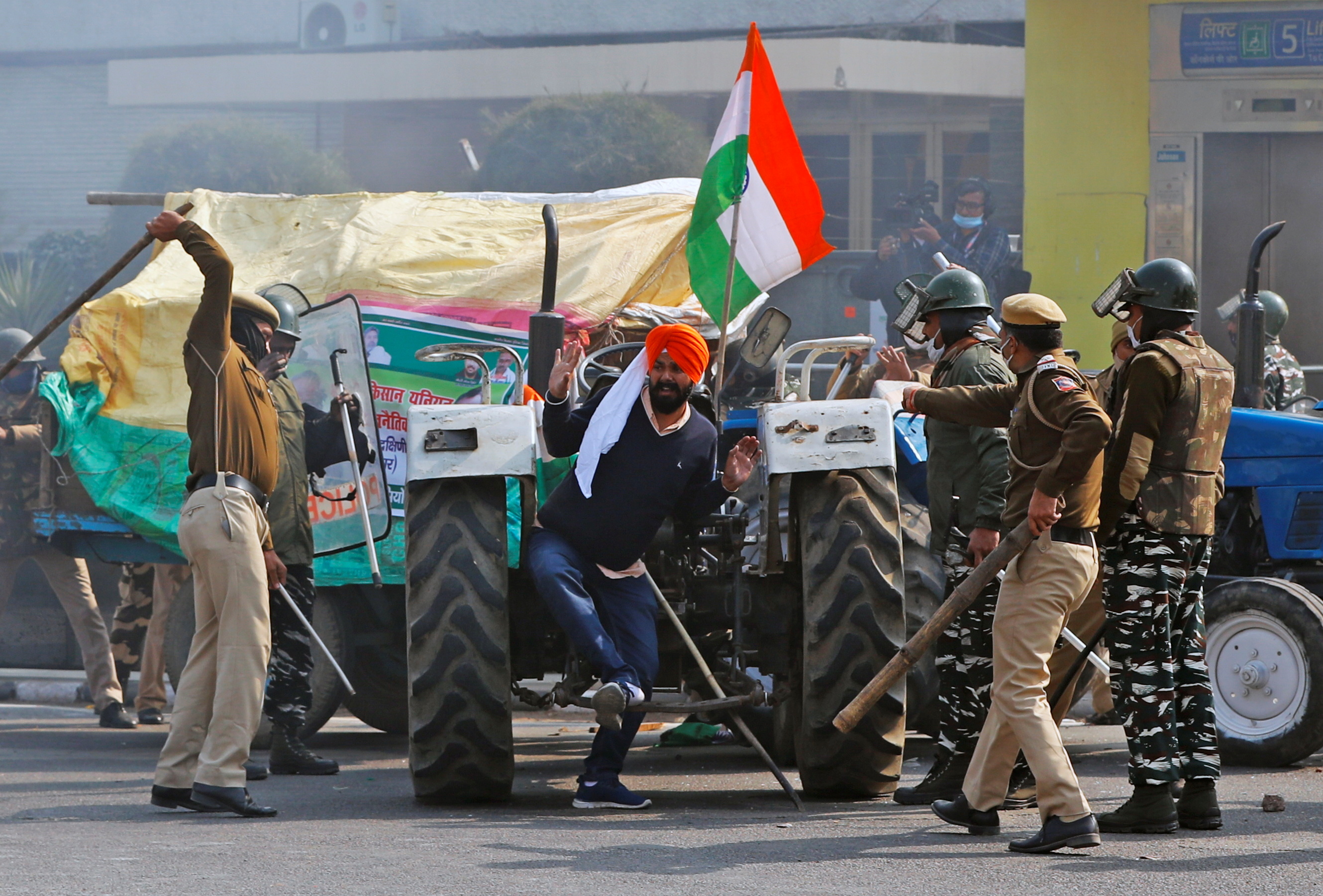 Thousands of agitating farmers riding on tractors and marching on foot into the national capital hours before, breaking police barriers and clashing with security forces who resorted to firing tear gas shells. Credit: Reuters