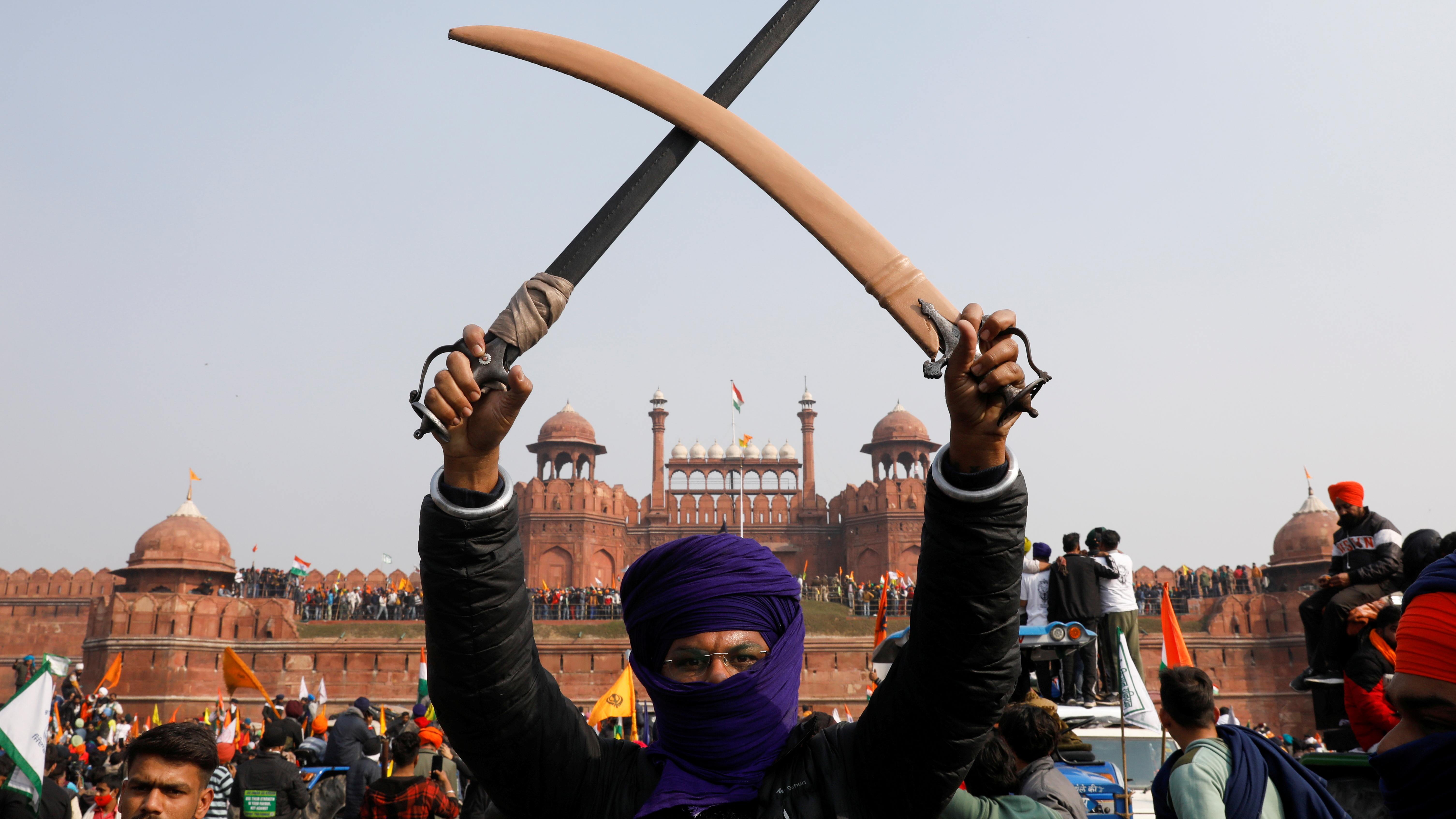 A tractor parade by the farmer unions meant to highlight their demands dissolved into anarchy on the streets of the national capital during the day as hordes of rampaging protesters broke through barriers, fought with police, overturned vehicles and hoisted a religious flag from the rampart of Red Fort, a privilege reserved for India's tricolour. Credit: Reuters