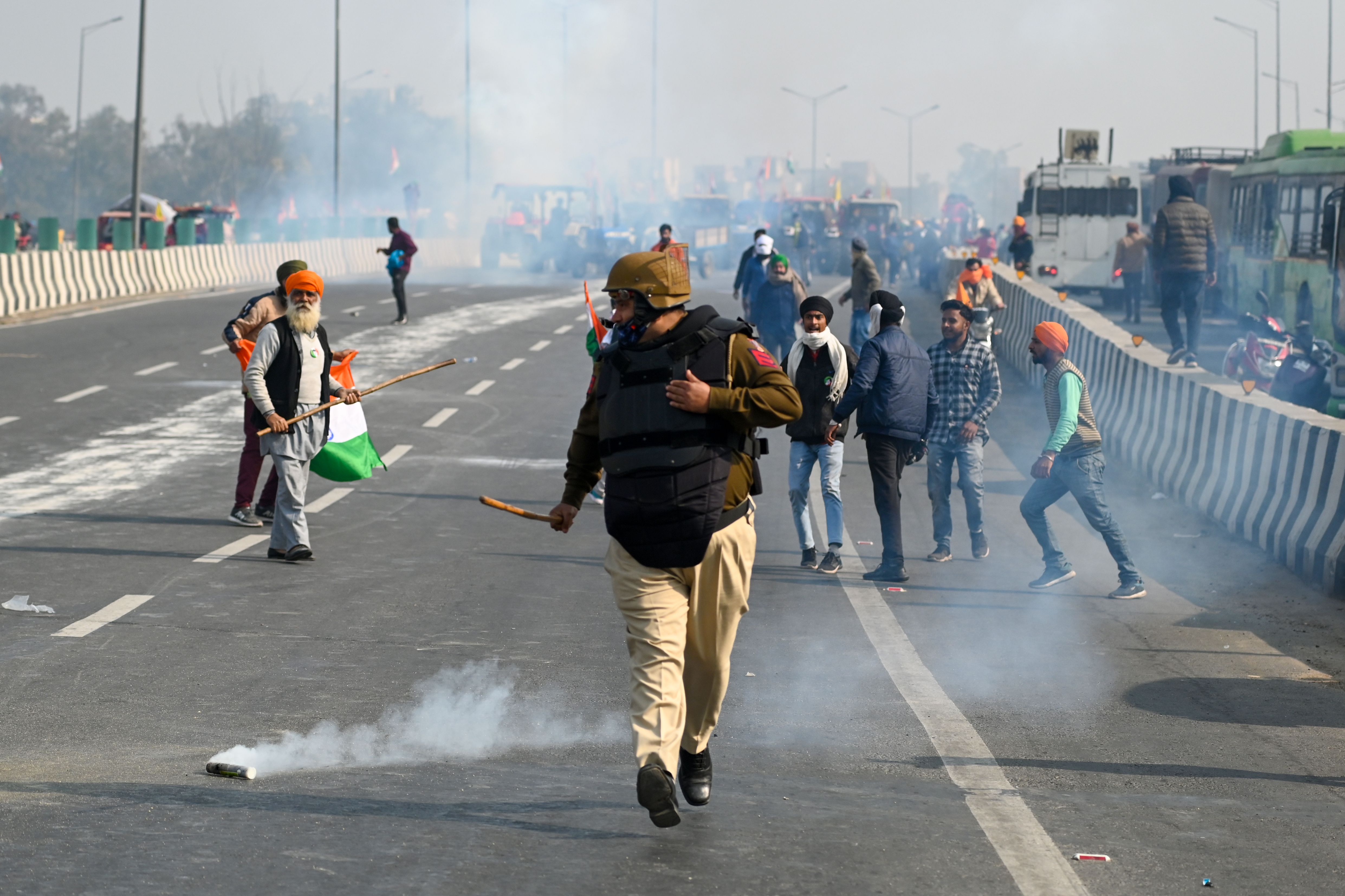 At Nangloi Chowk in west Delhi and at Mukarba Chowk farmers broke cemented barricades and police used tear gas to disperse them. The protesting farmers also reached Delhi's ITO area, a few kilometres away from Parliament. Credit: AFP