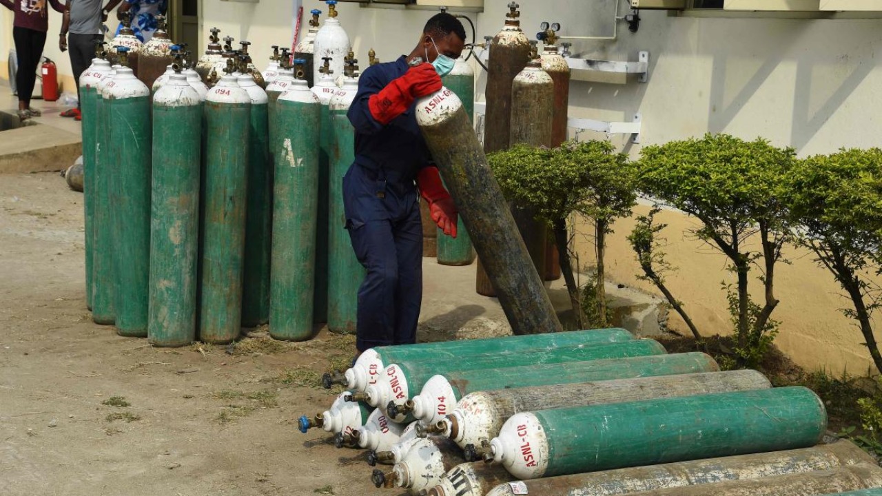 In this file photo taken on January 22, 2021 A worker arranges oxygen cylinders at Lagos State Isolation Centre in Yaba, Lagos. - The number of confirmed Covid-19 cases in Nigeria is increasing rapidly following daily reports by the Nigeria Centre for Disease Control (NCDC) even as Lagos, Nigeria's commercial capital, accounted for the highest number of cases in the country. Credit: AFP.