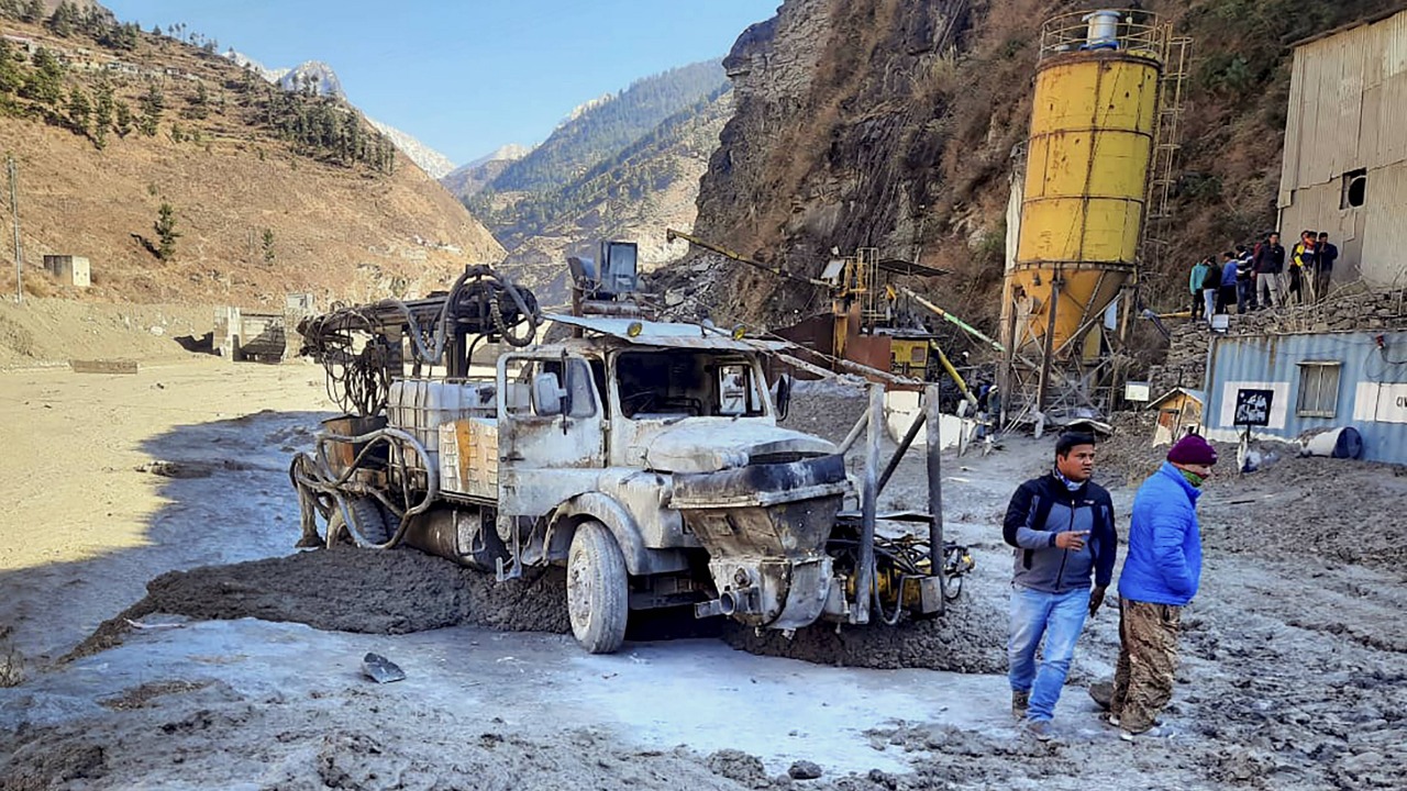 Locals inspect the site near damaged Dhauliganga hydropower project at Reni village, after a glacier broke off in Joshimath causing a massive flood in the Dhauli Ganga river, in Chamoli district of Uttarakhand,. Credit: PTI Photo.