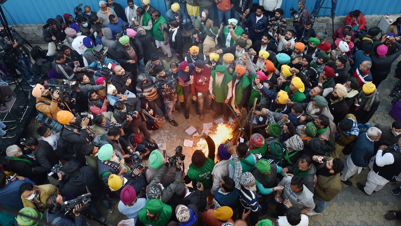 January 13 | Protesting farmers gathered around a bonfire and burnt copies of the new farm laws | Credit: PTI File Photo