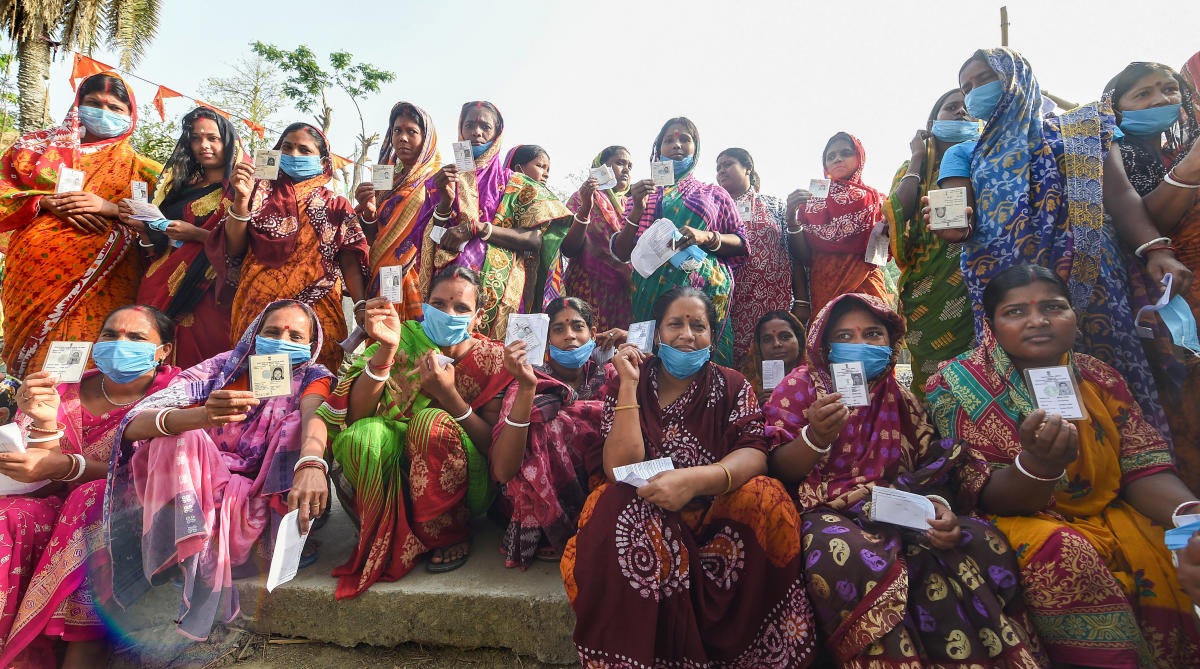 Voters show their ID cards as they arrive to cast their votes during the second phase of West Bengal Assembly polls, in Nandigram. Credit: PTI Photo