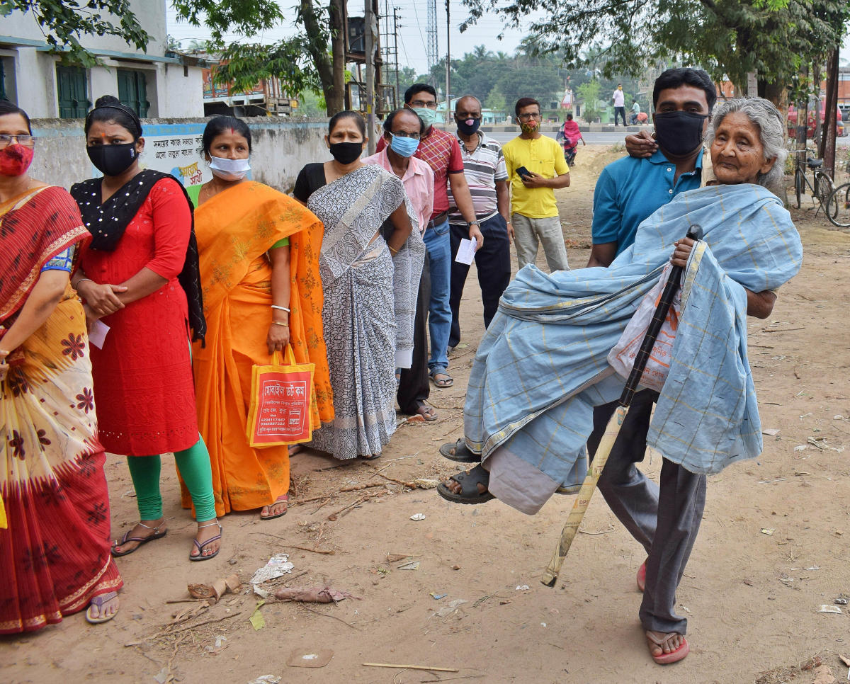 An elderly woman being brought at a polling booth to cast her vote for the 6th phase of West Bengal Assembly polls, in Nadia, Thursday, April 22, 2021. Credit: PTI Photo