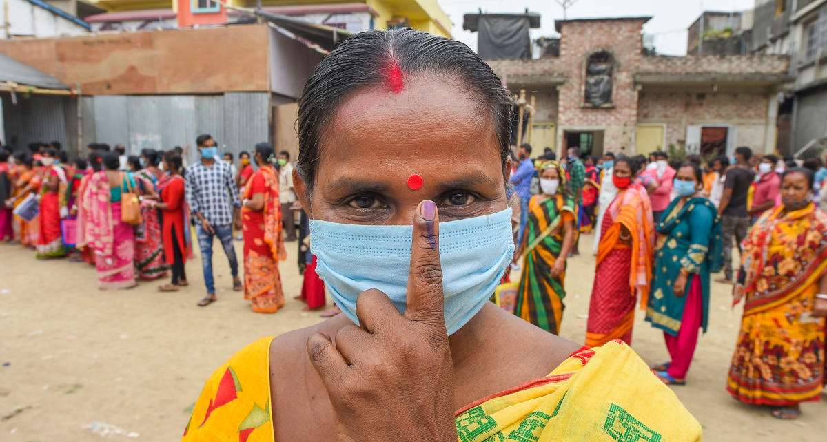 A voter shows her inked finger after casting her vote at a polling station during the 6th phase of West Bengal State Assembly Elections at Khardha, in North 24 Parganas, Thursday, April 22, 2021. Credit: PTI Photo