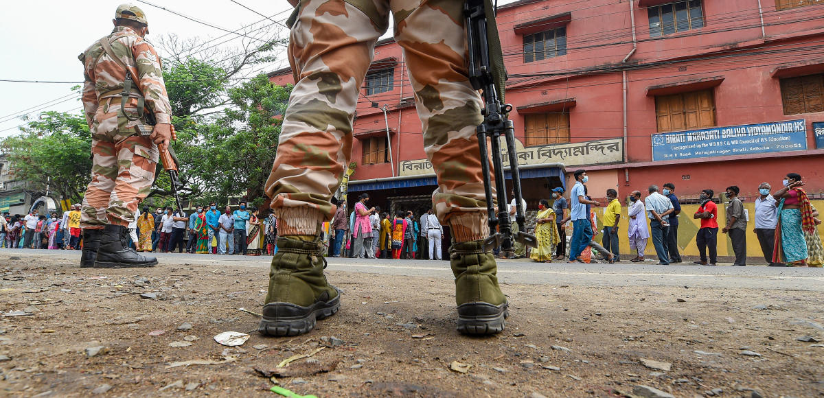 People stand in a queue to cast their vote at a polling station during the 6th phase of State Assembly Election at Birati, in North 24 Parganas, Thursday, April 22, 2021. Credit: PTI Photo
