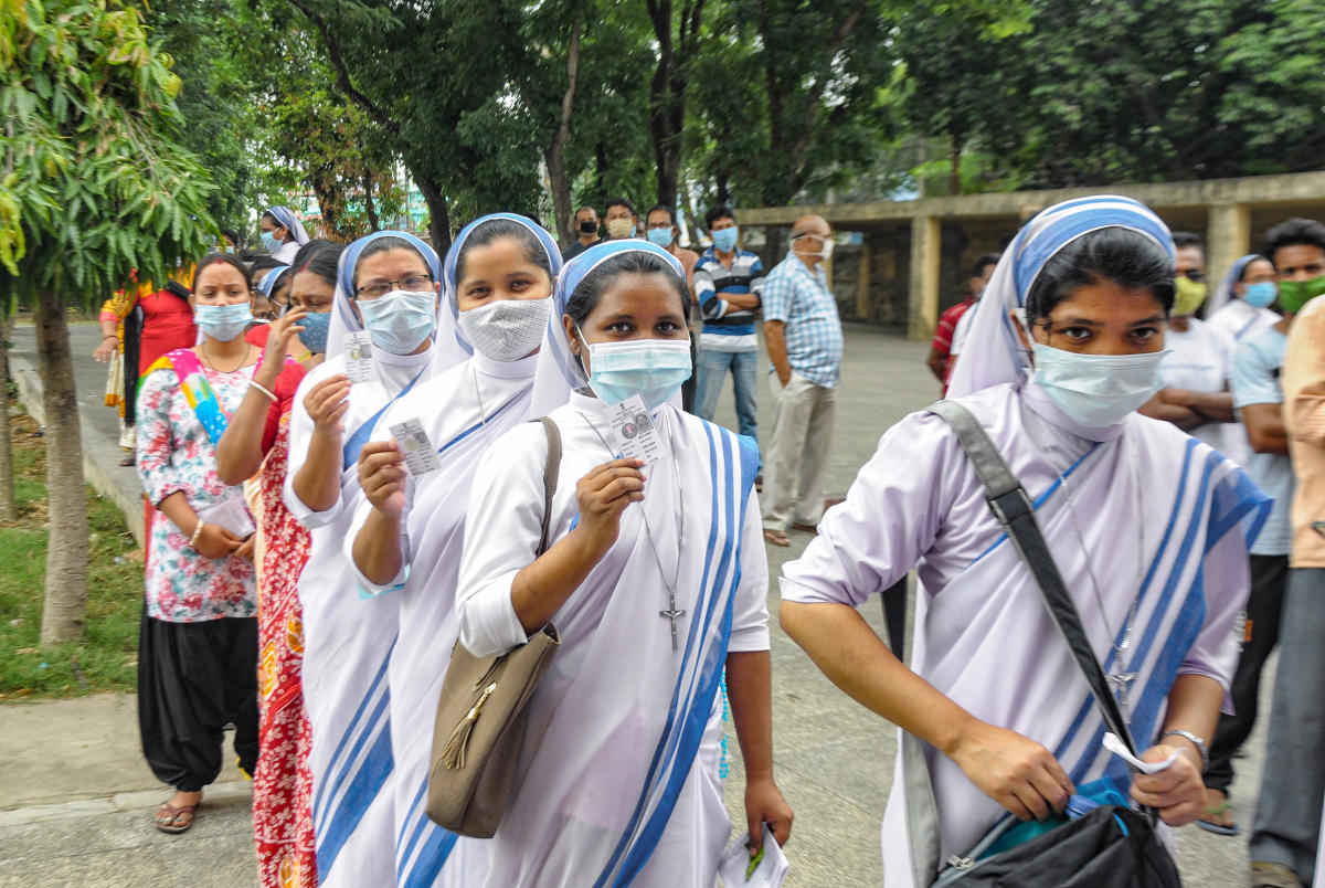 Nuns stand in a queue to cast their votes at a polling station during the 6th phase of West Bengal Assembly Elections at Krishnagar, in Nadia, Thursday, April 22, 2021. Credit: PTI Photo