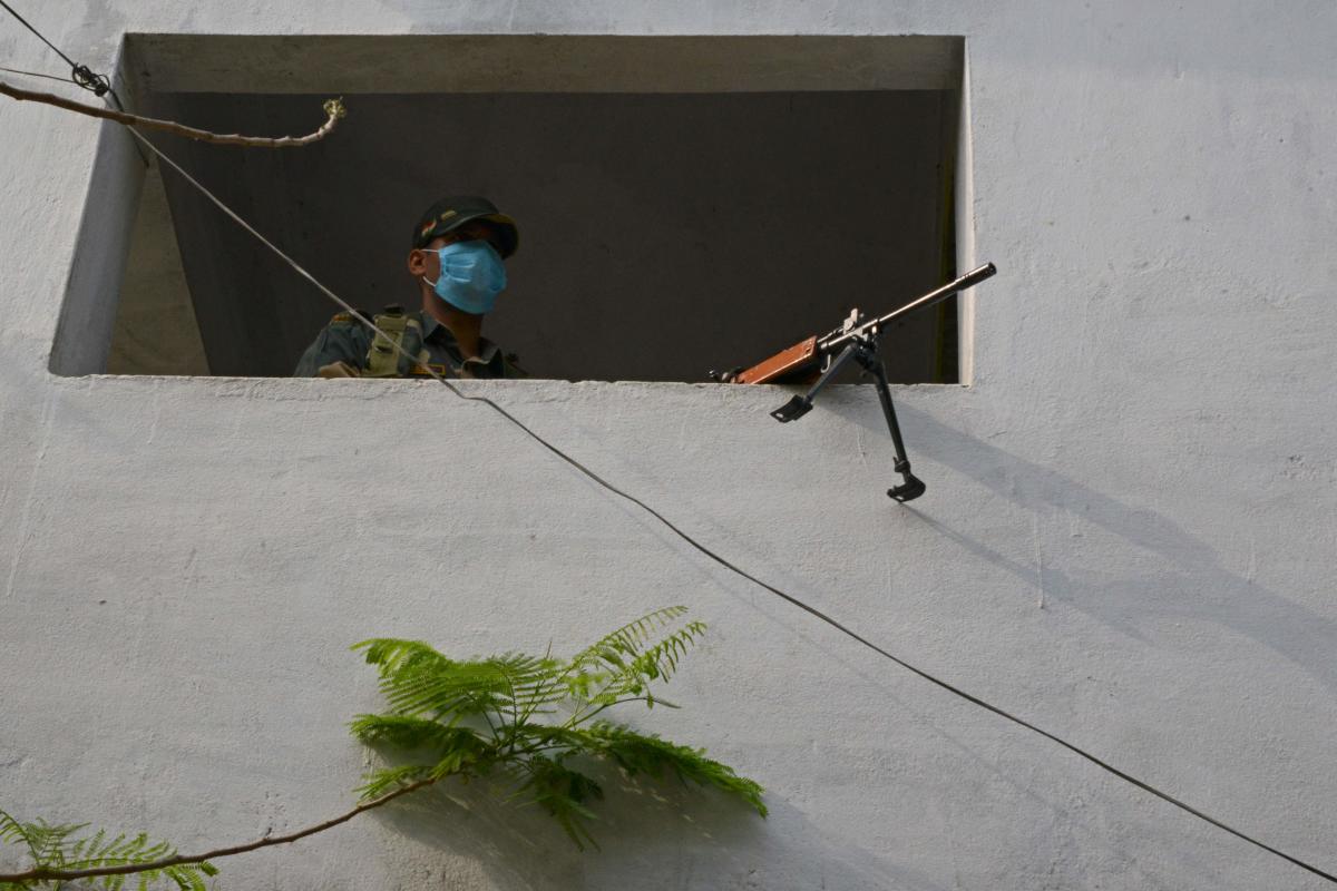 A paramilitary trooper keeps vigil at a polling station during the 6th phase of the West Bengal's state legislative assembly elections on the outskirts of Chopra in North Dinajpur district on April 22, 2021.  Credit: AFP Photo