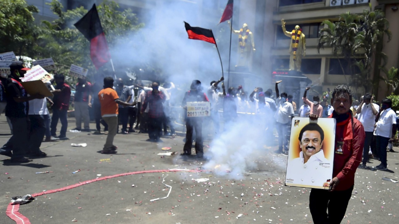 Party workers celebrate the DMK's performance in the Tamil Nadu elections by bursting firecrackers.