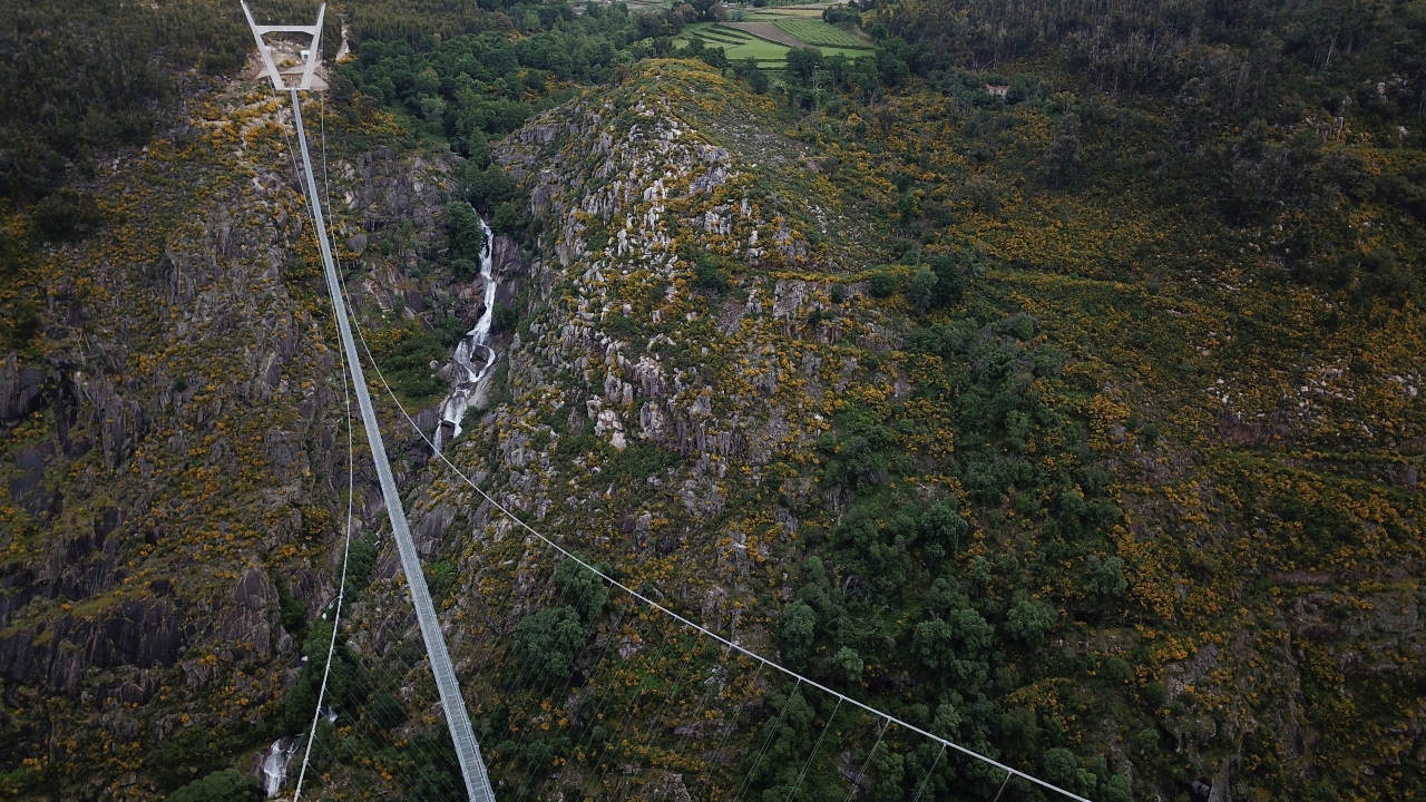 Held up by steel cables and two massive towers on each side, it wobbles a little with every step.