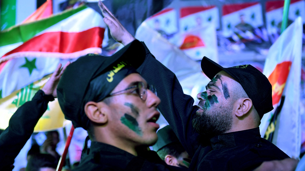 Members of Syria's pro-government Liwaa al-Quds gesture during a march marking the yearly al-Quds (Jerusalem) day, at the al-Nayrab camp for Palestinian refugees east of Syria's northern city of Aleppo. Credit: AFP Photo