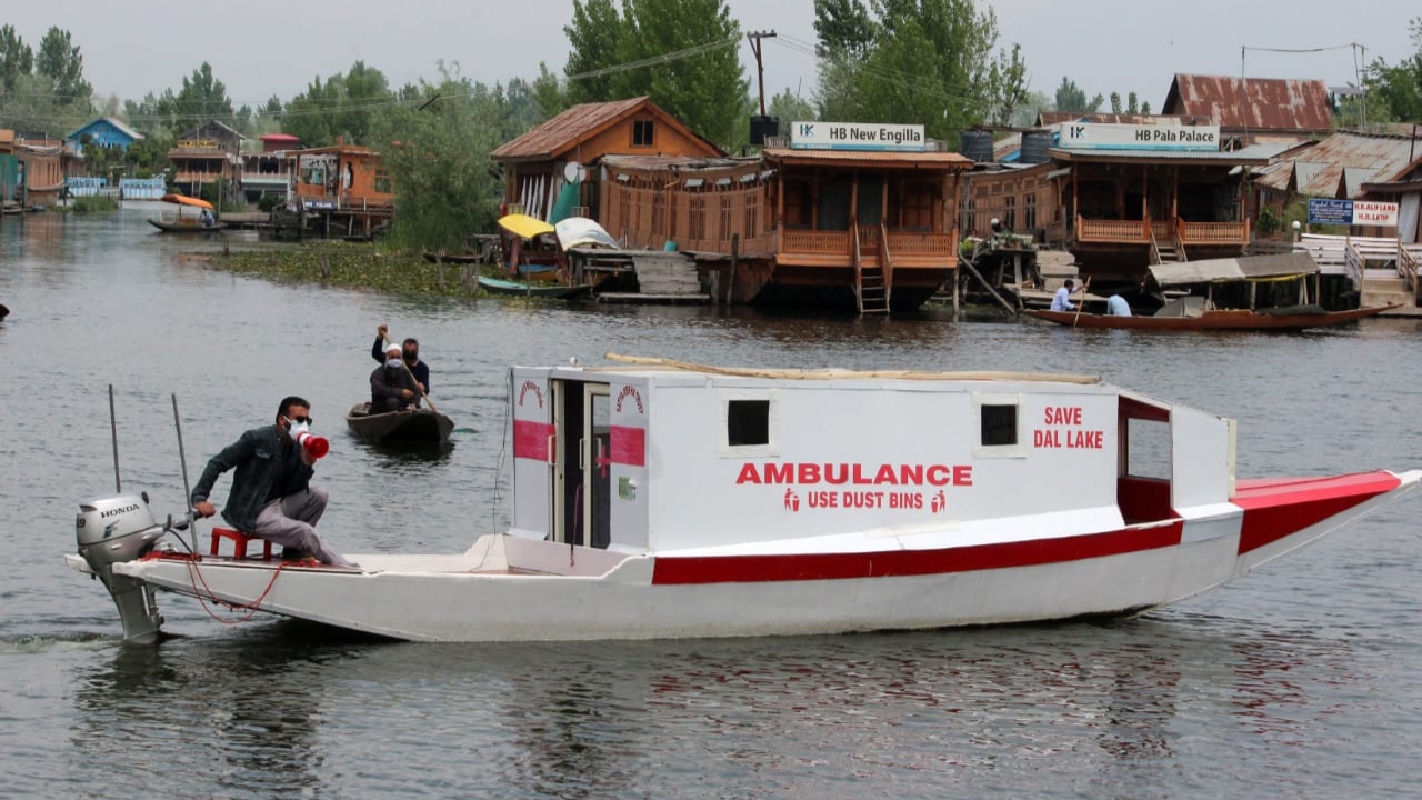 Tariq Ahmad Patloo in a Shikara Ambulance makes an announcement to follow Covid-19 protocols at Dal Lake in Srinagar.