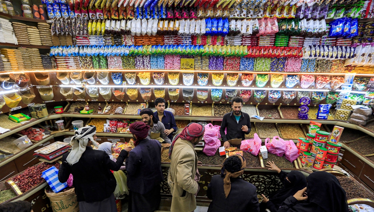 People shop for dried fruits and nuts at an open-air market in Yemen's capital, Sanaa. Credit: AFP Photo