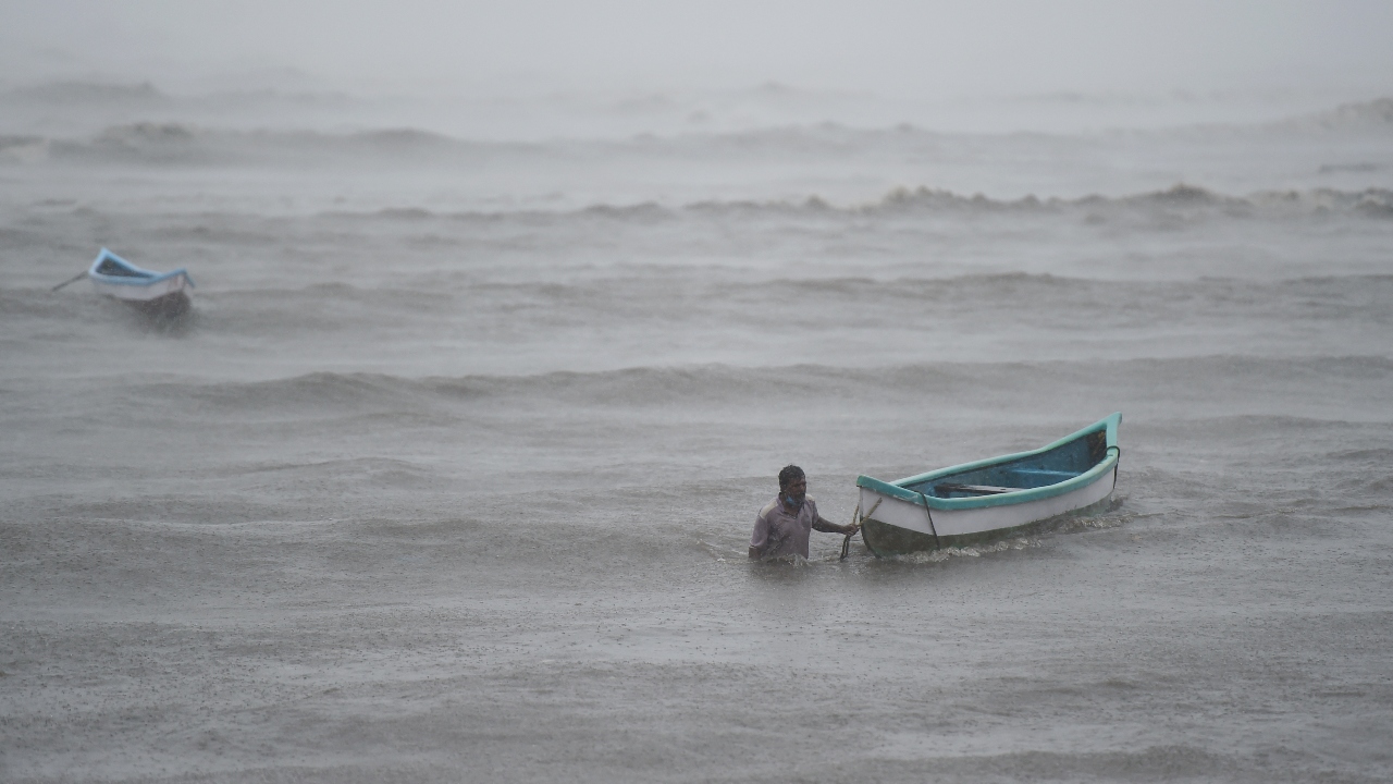 A fisherman tries to pull his boat ashore to a safe place during the formation of cyclone Tauktae, at Bandra. Credit: PTI