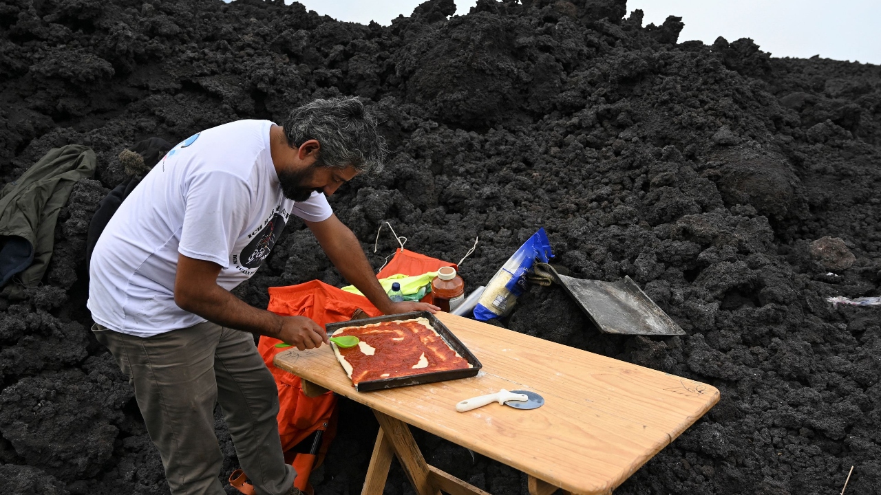 In his makeshift kitchen, Garcia spreads the dough on a metal platter that can resist temperatures up to 1,000 degrees Celsius (1,800 degrees Fahrenheit), slathers it with tomato sauce, a generous helping of cheese and pieces of meat.