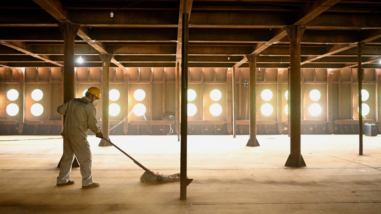 A worker sweeping inside a replica of the Titanic ship in China.