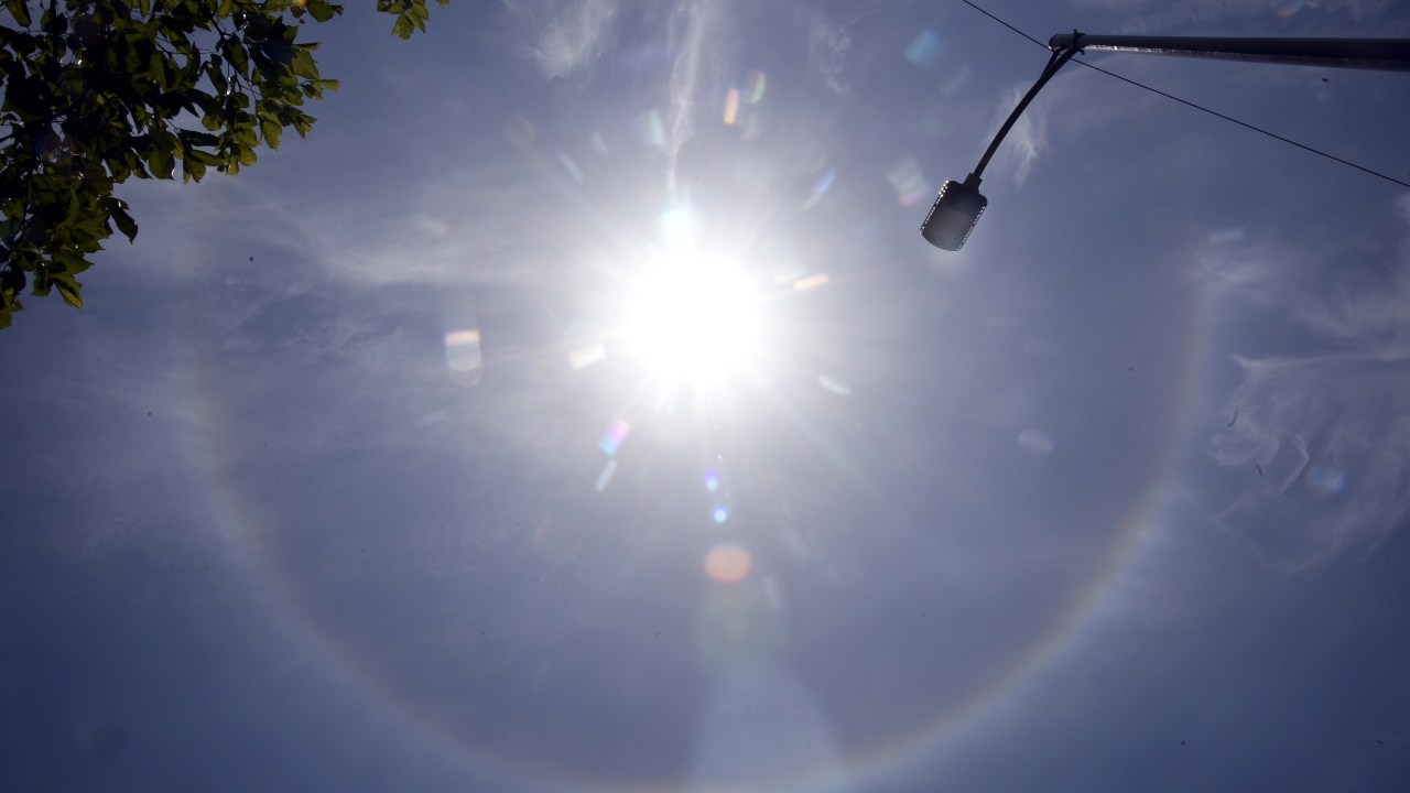 Halos around the sun are caused by the refraction or the splitting of sunlight by ice crystals in the atmosphere. Credit: DH Photo