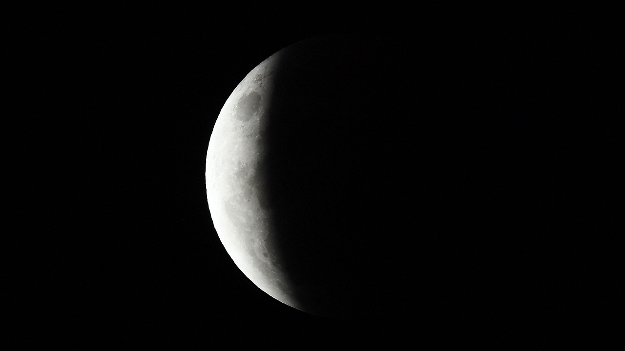 The full moon is seen during the partial eclipse in Sydney on May 26, 2021. Credit: AFP Photo