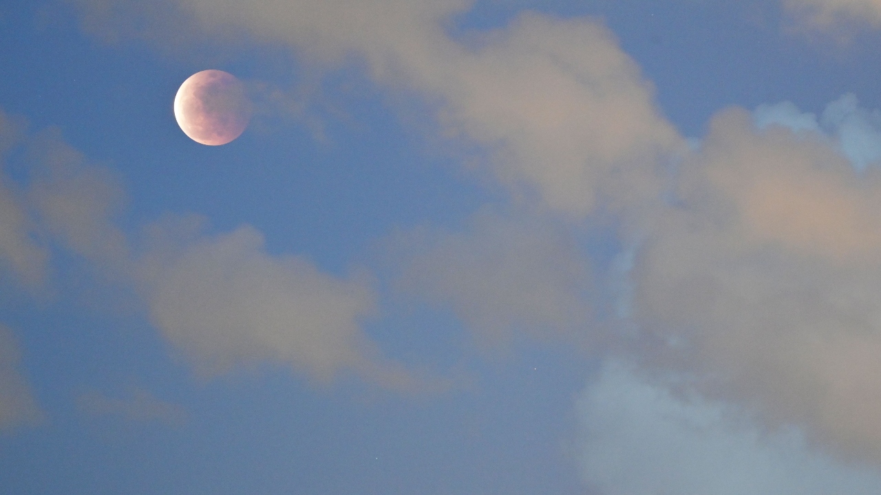 The moon is pictured above Hong Kong on May 26, 2021. Credit: AFP Photo