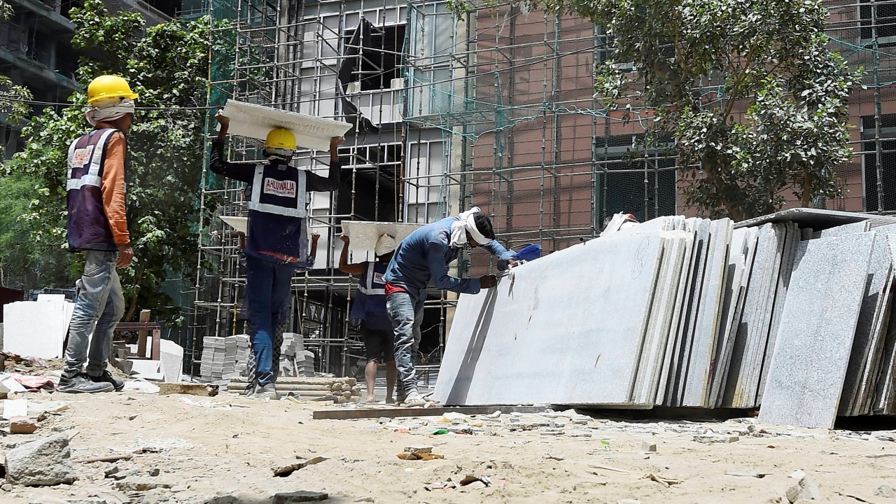 Workers are seen at a construction site as unlock process begins in New Delhi. Credit: PTI Photo