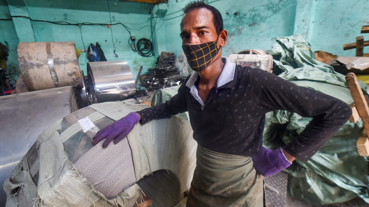 A worker at a factory in the Wazirpur Industrial area. Credit: PTI Photo