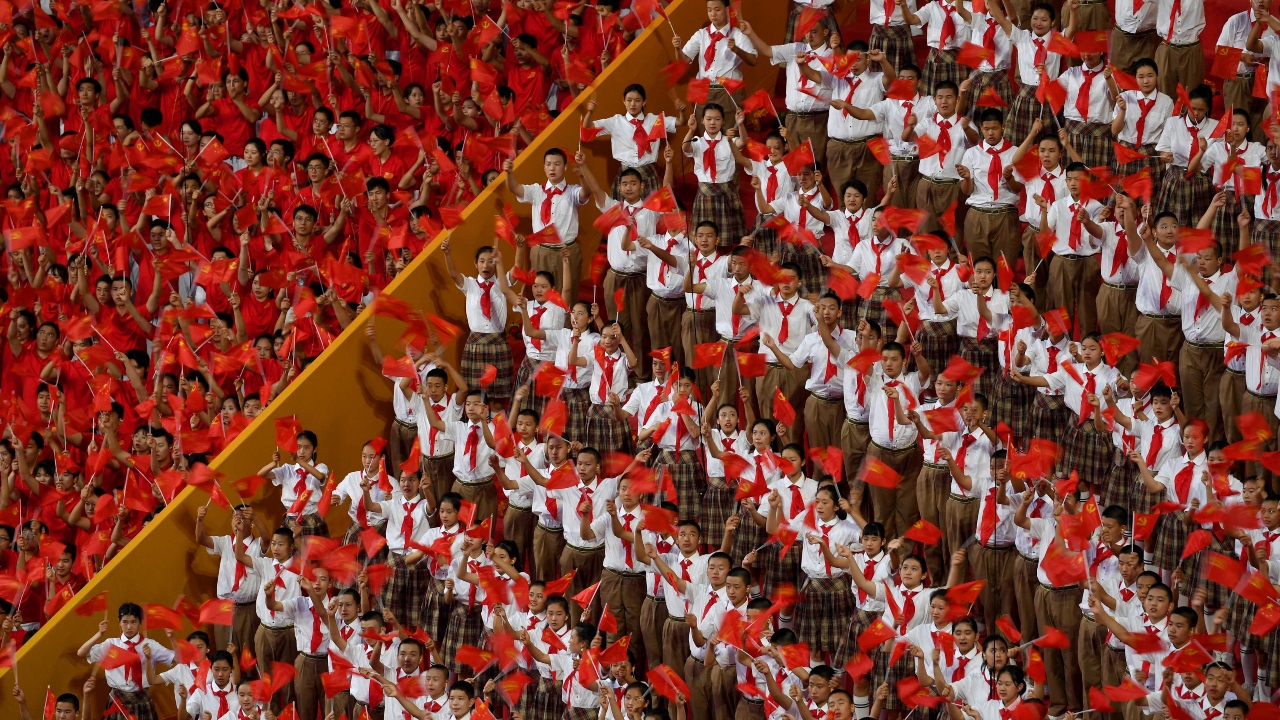In the capital's immense Tiananmen Square, tens of thousands of handpicked spectators cheered, sang, and waved flags. Credit: AFP Photo