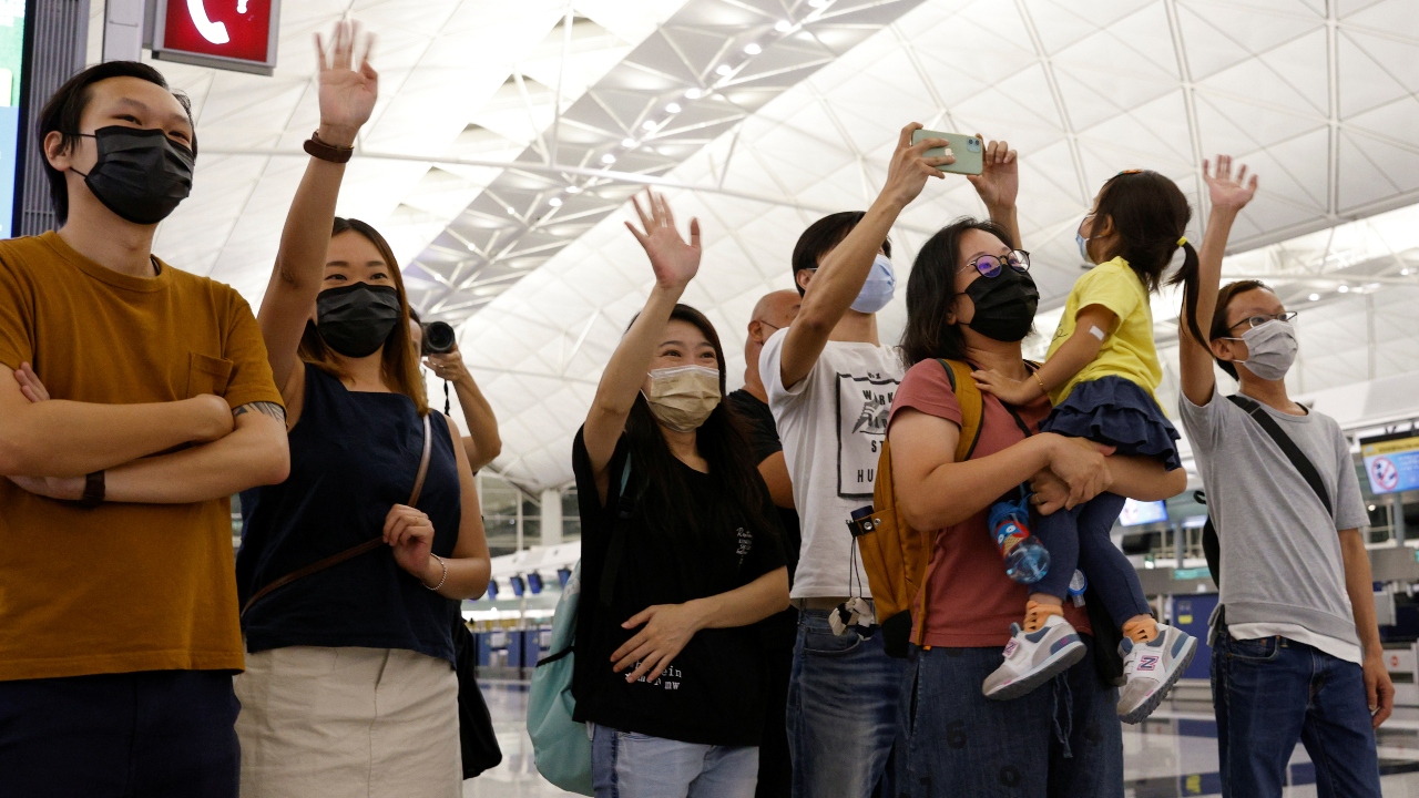 People bid an emotional farewell to their friends at the Hong Kong International Airport.