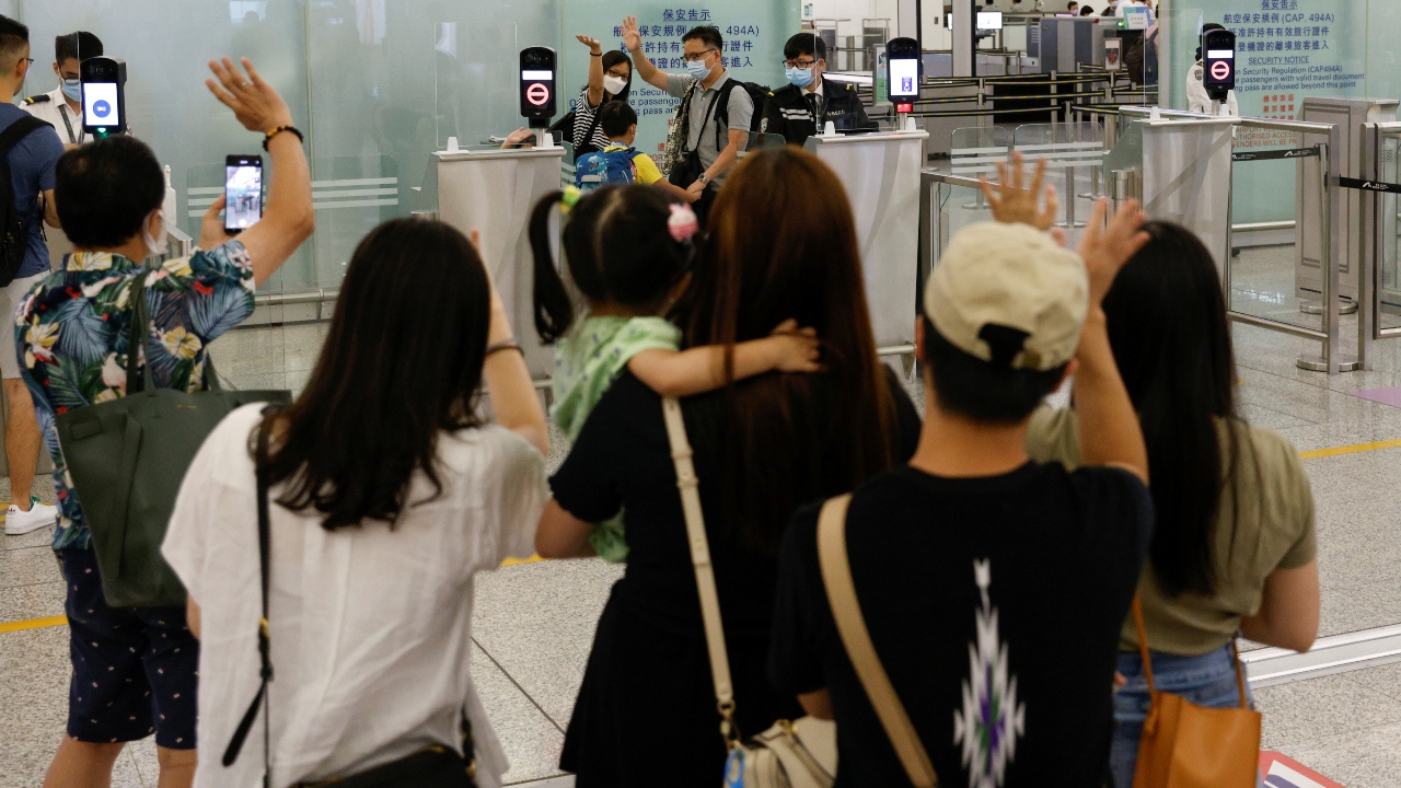 People bid farewell to their friends departing to United Kingdom at the Hong Kong International Airport.