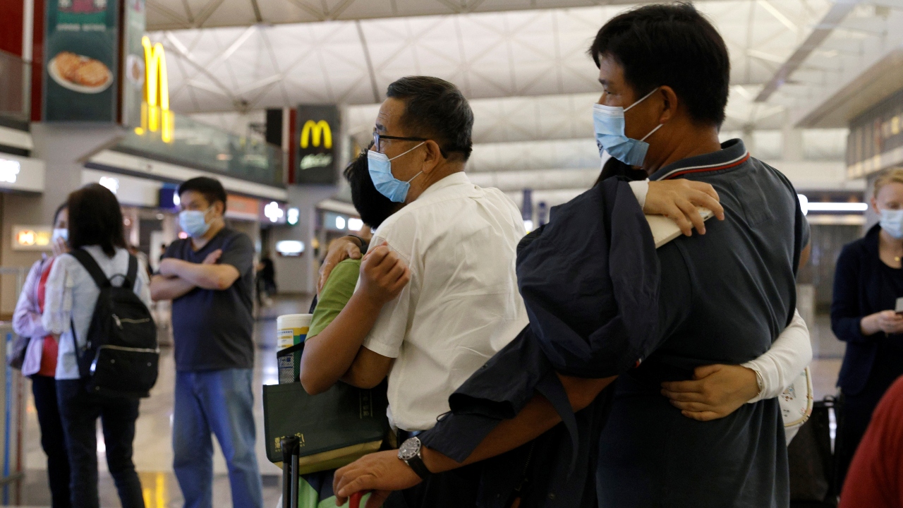Passengers hug their family members before departing to United Kingdom.