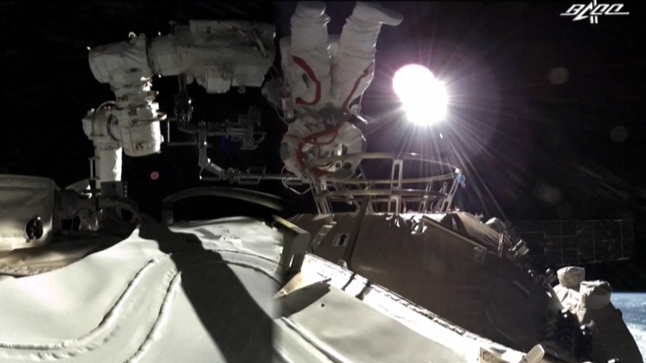 Liu Boming and Tang Hongbo were shown by state TV climbing out of the airlock as Earth rolled past below them. The third crew member, commander Nie Haisheng, stayed inside. Credit: AFP Photo