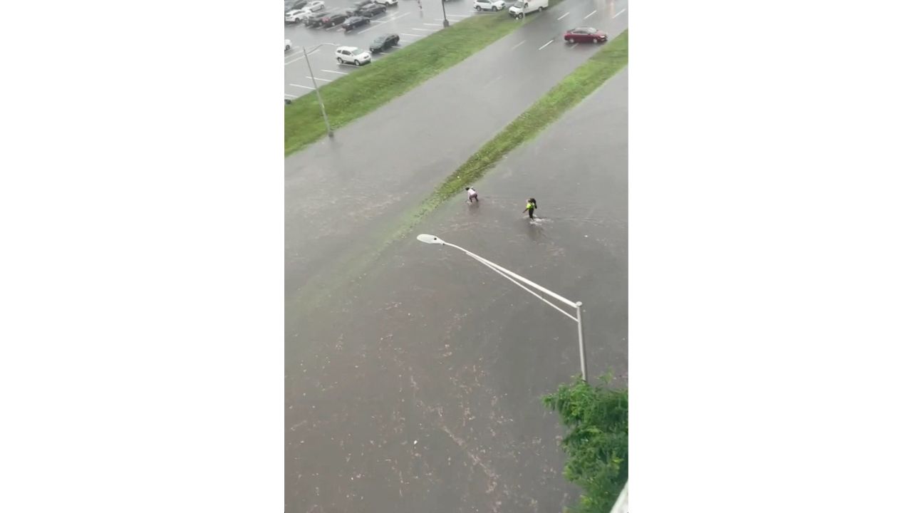 People wade through a flooded street in Yonkers, New York. Credit: Tri-State Weather/via Reuters