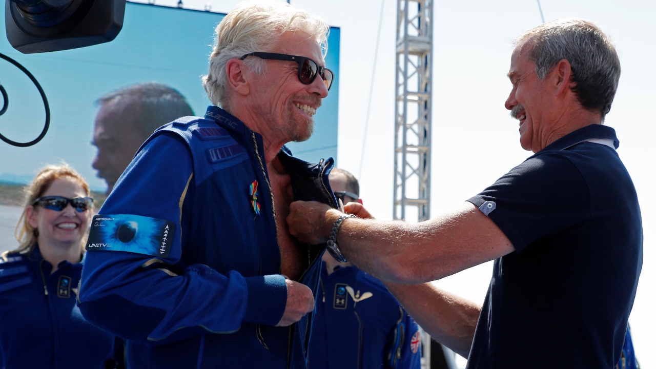 Retired Canadian astronaut Chris Hadfield pinned Virgin-produced astronaut wings onto the blue flight suits worn by Branson and his team. Official wing pins from the Federal Aviation Administration will be presented later, a company spokesman said. Credit: Reuters Photo