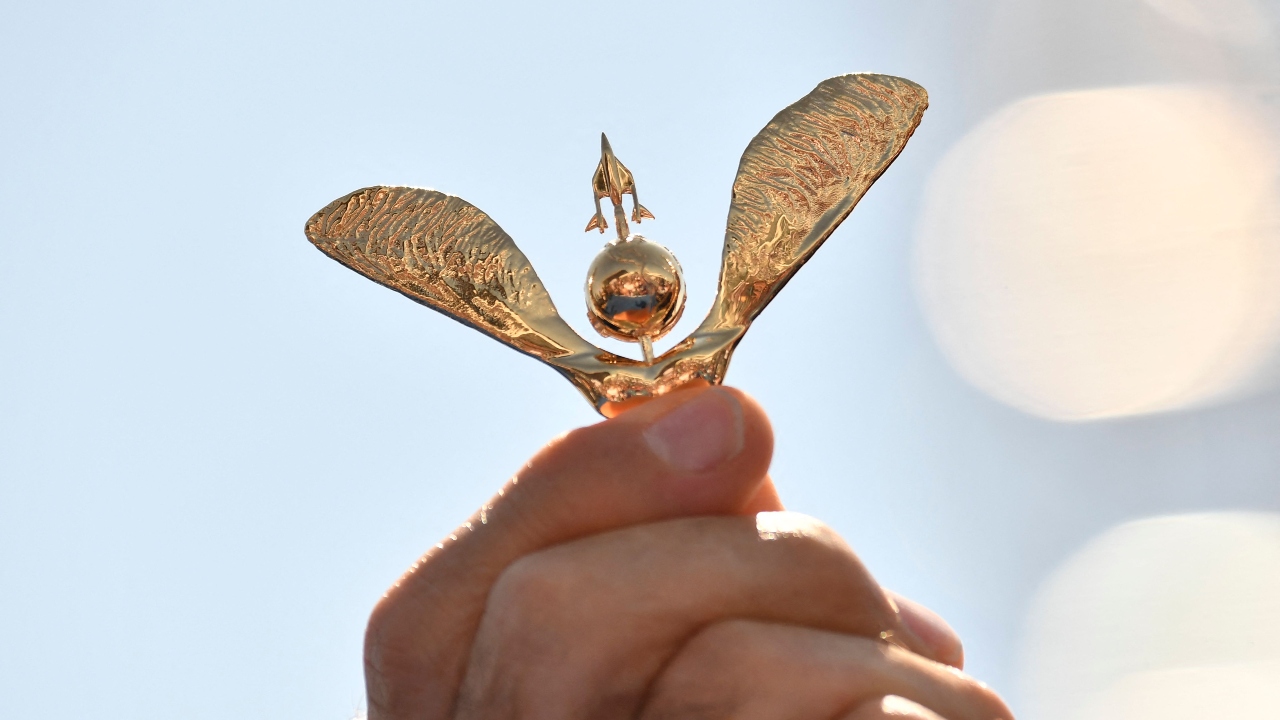 Astronaut Chris Hadfield holds wings before presenting to crew members. Credit: AFP Photo