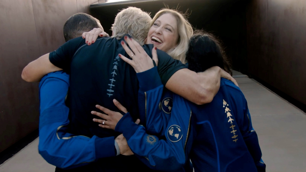 Virgin Galactic's chief astronaut instructor Beth Moses embraces Richard Branson and other crew as he arrives at Spaceport America. Credit: Reuters Photo