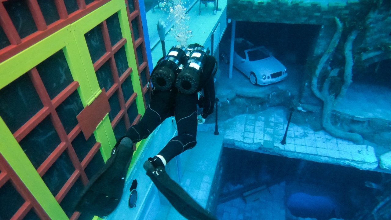 Divers go down through a landscape of a sunken city, with sound and lighting. Credit: AFP Photo