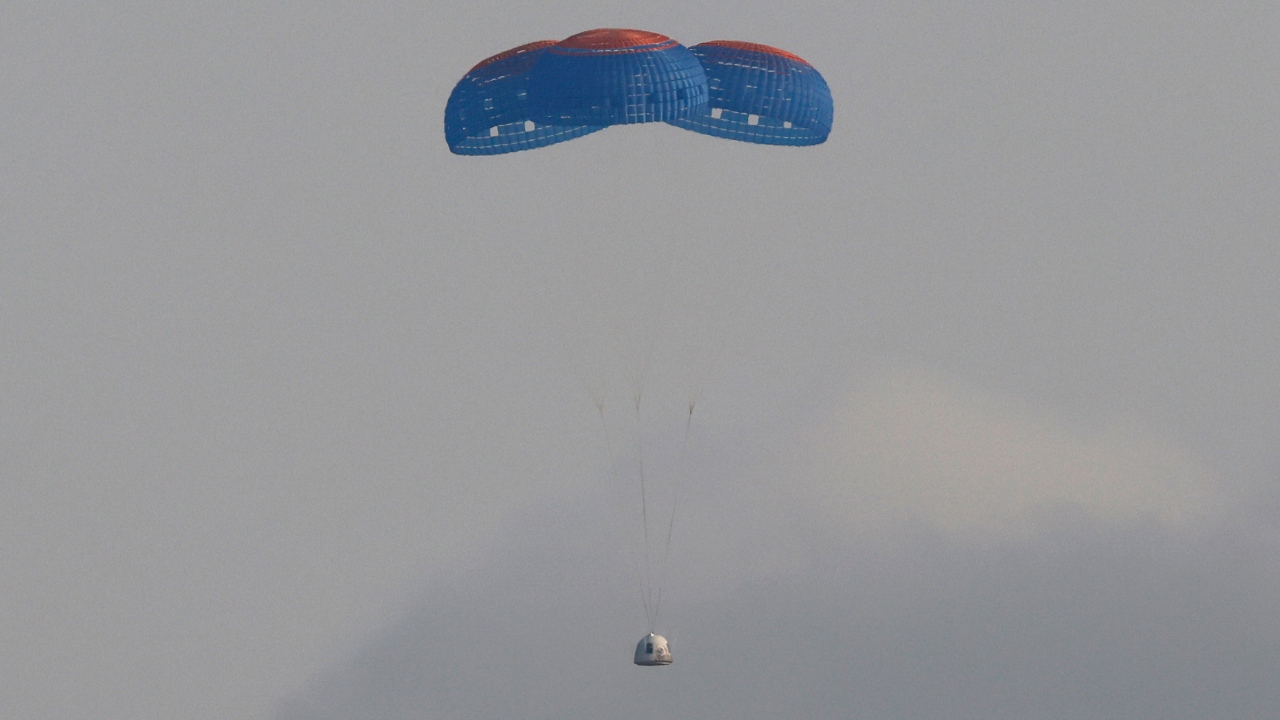 The capsule carrying billionaire businessman Jeff Bezos and three crew members returns by parachute after their flight aboard Blue Origin's New Shepard rocket near Van Horn, Texas in US. Credit: Reuters Photo