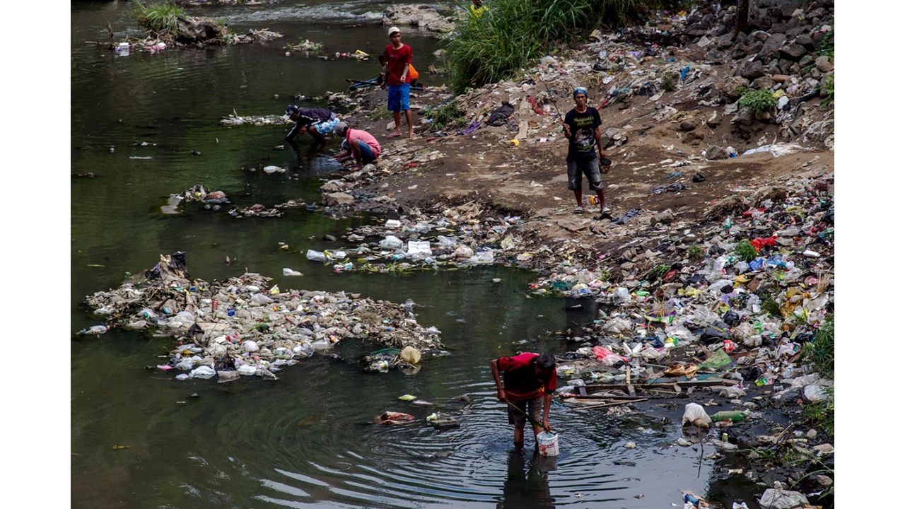 Fishing in the Brantas river of the East Java province, Indonesia, means going through loads of plastic trash, discarded by the residents of thousands of buildings. Photo by Fully Syafi Handoko (Indonesia)