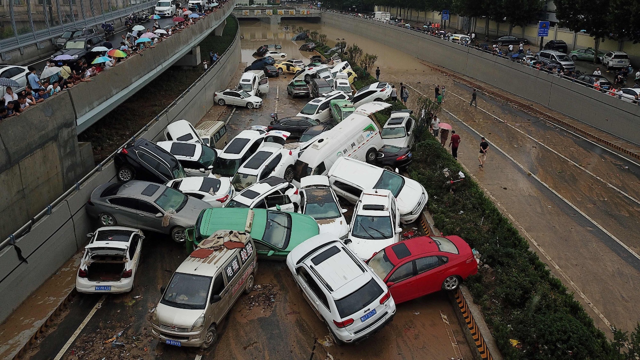 An aerial view shows cars sitting in floodwaters at the entrance of a tunnel after heavy rains hit the city of Zhengzhou, China. Credit: AFP Photo