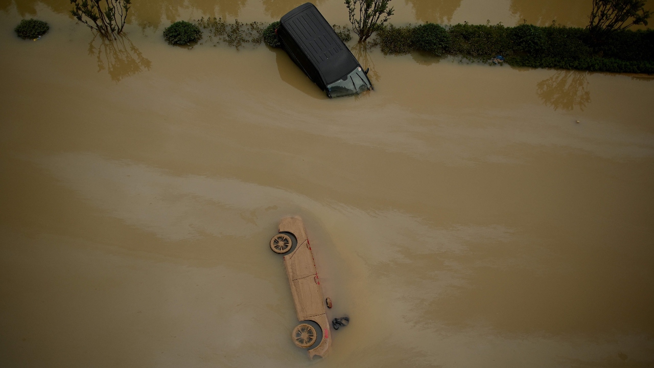 Cars sit in floodwaters following heavy rains, in Zhengzhou in China. Credit: AFP Photo