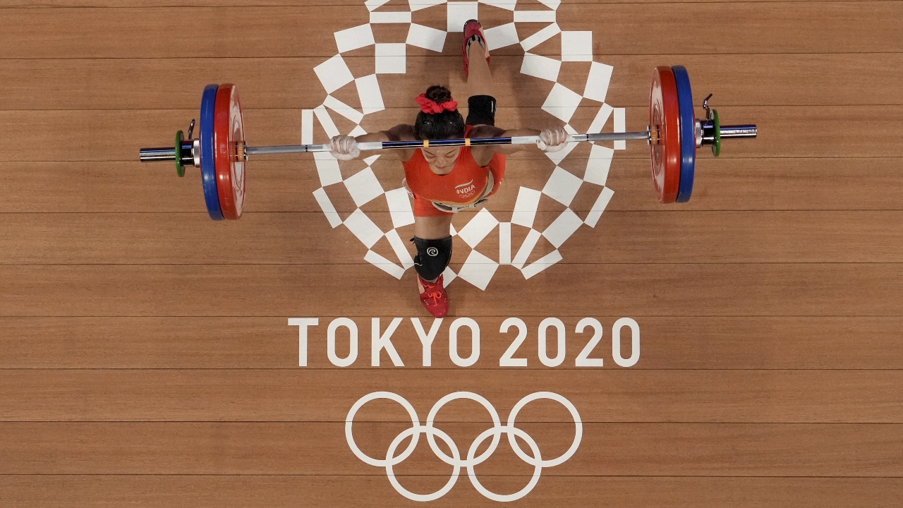 The diminutive iron lady from Manipur lifted a total of 202kg (87kg+115kg) to better Karnam Malleswari's bronze in the 2000 Sydney Olympics. Credit: PTI Photo