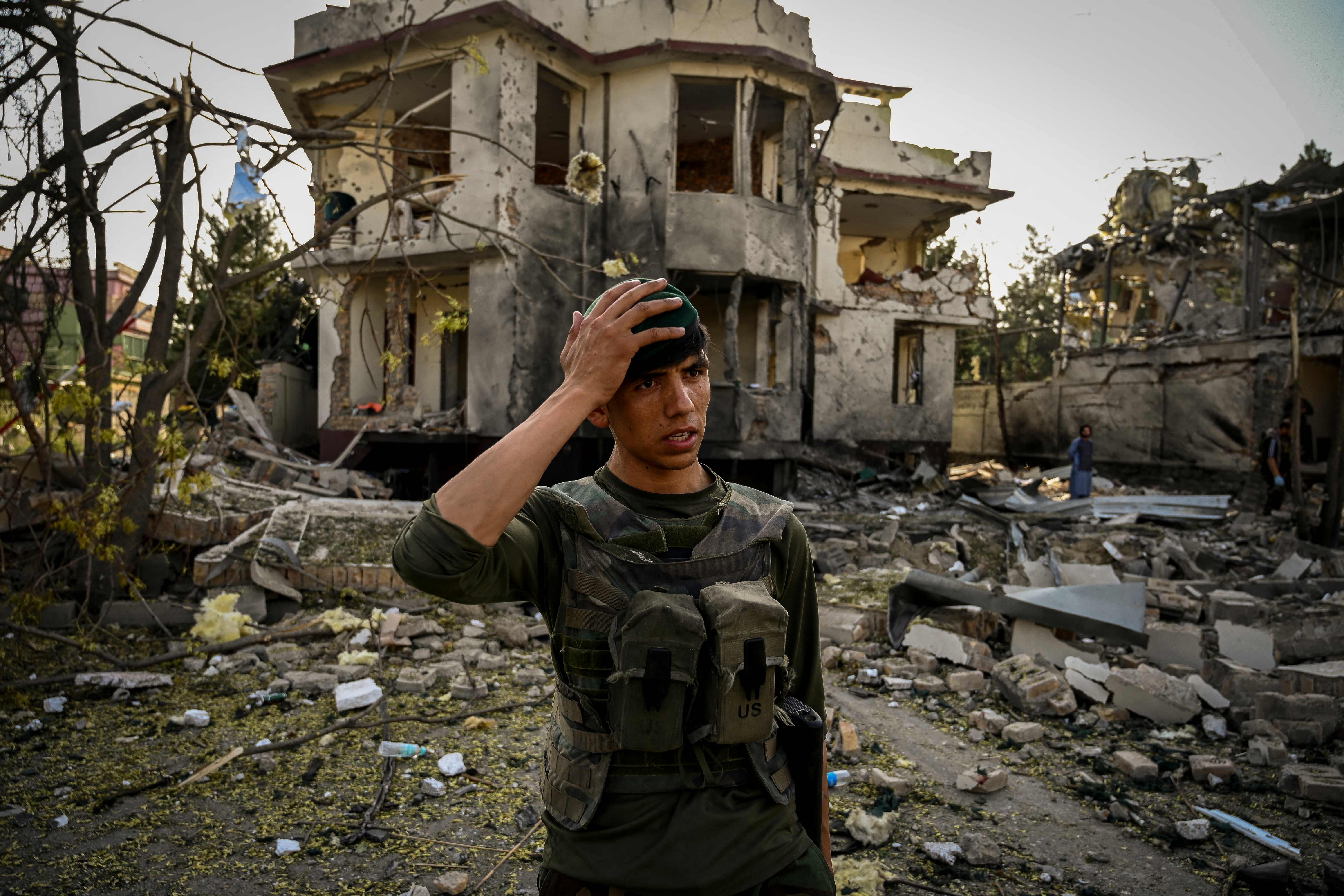 An Afghan security personnel gestures as he stands guard at the site a day after a car bomb explosion in Kabul. Credit: AFP Photo