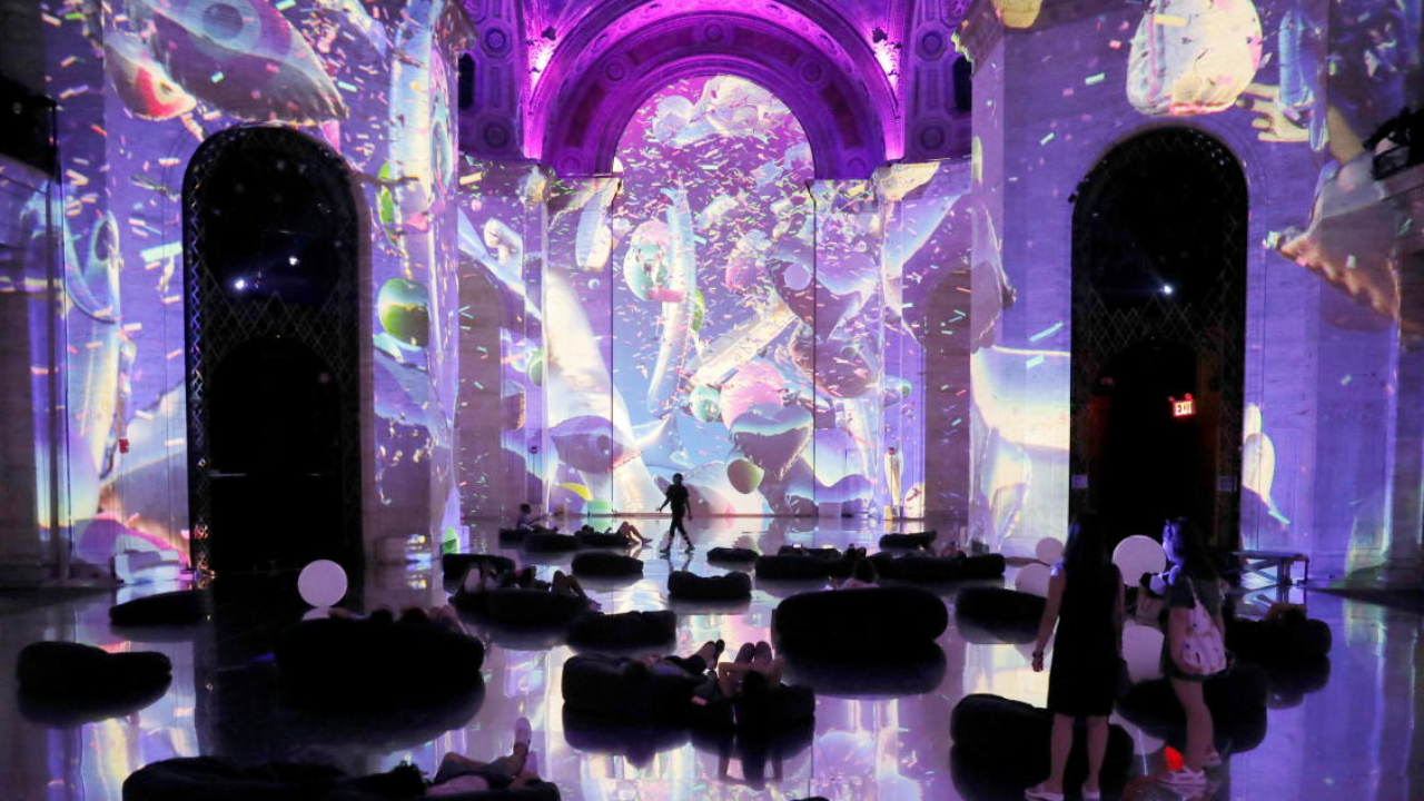 People lay on a reflective floor while attending SuperReal, an immersive multimedia art installation, in Manhattan, New York City. Credit: Reuters Photo