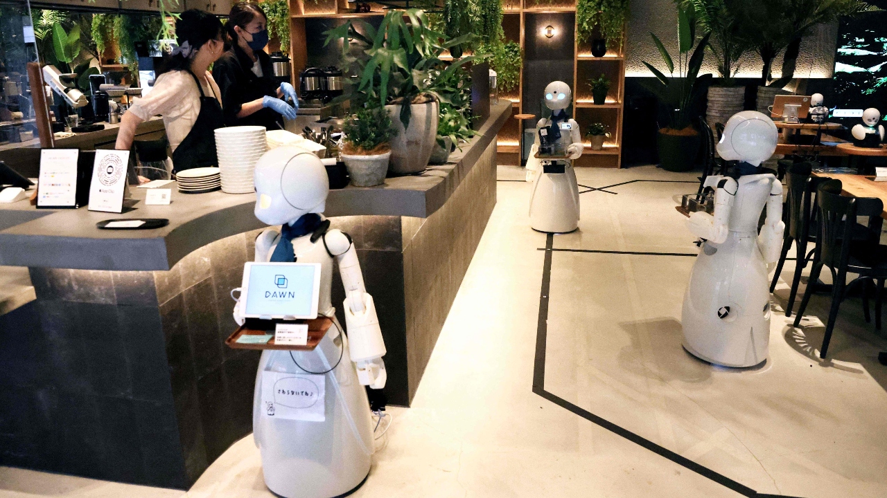 A humanoid robot delivers drinks to customers at the Dawn Cafe in Tokyo. Credit: AFP Photo