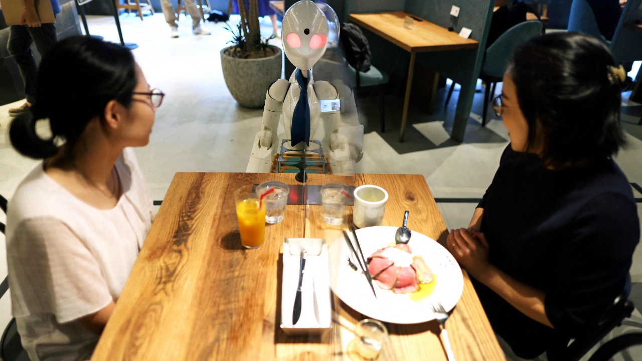 A humanoid robot delivers drinks to customers at the Dawn Cafe in Tokyo. Credit: AFP Photo