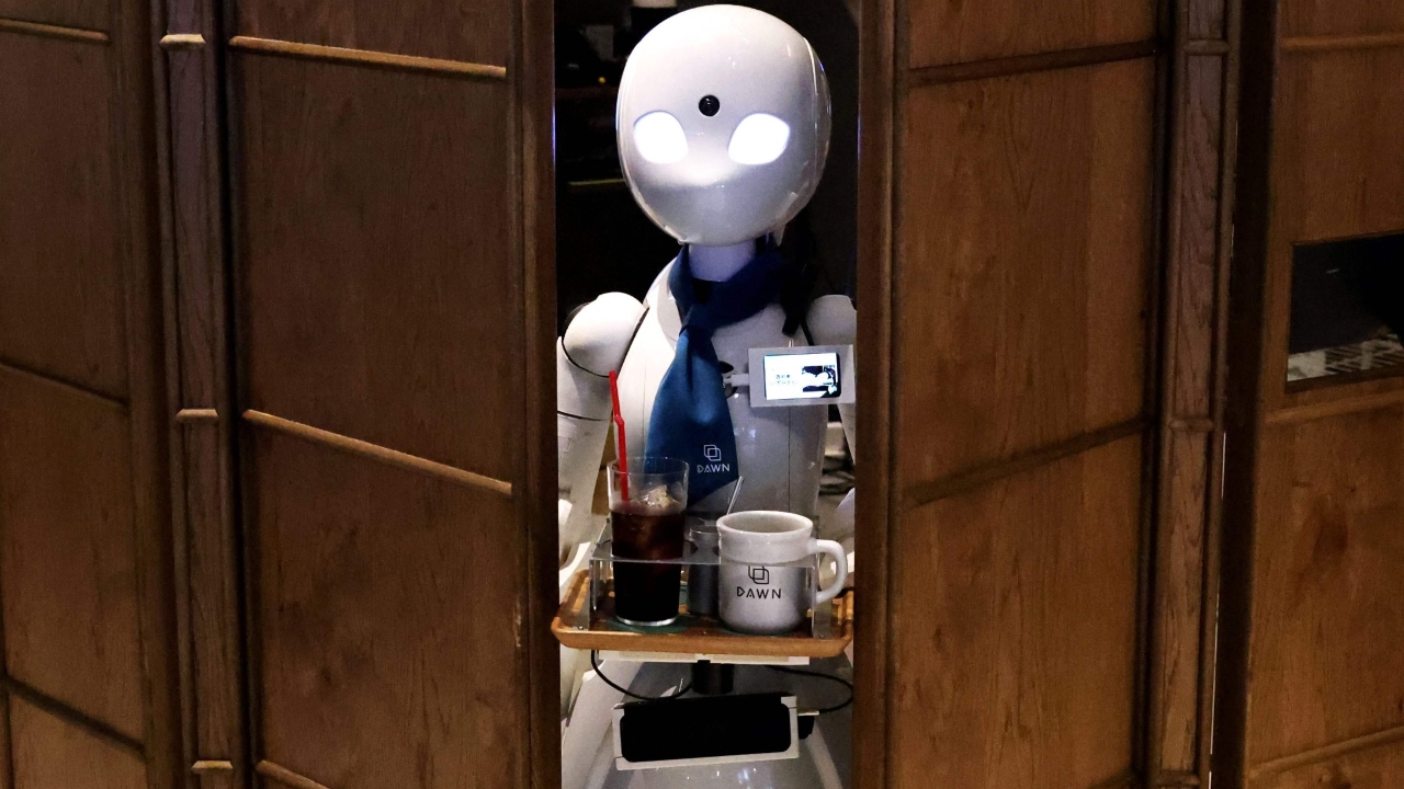 Around 20 miniature robots with almond-shaped eyes sit on tables and in other parts of the cafe, which has no stairs and smooth wooden floors large enough for wheelchairs. Credit: AFP Photo