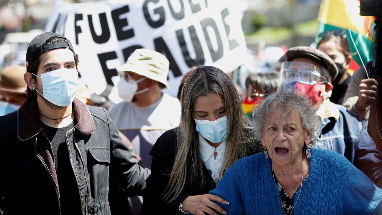 Children of Bolivia's former President Jeanine Anez, Jose Armando Rivera Anez, Carolina Rivera Anez and the President of the Permanent Human Rights Assembly of Bolivia (APDHB), Amparo Carvajal, take part in a march demanding that the former president defend herself in freedom in La Paz, Bolivia. Credit: Reuters photo