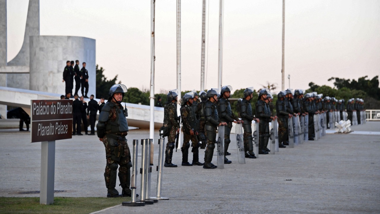 Brazilian army soldiers stand guard outside the Planalto Palace during a protest of indigenous people in Brasilia. Credit: AFP Photo